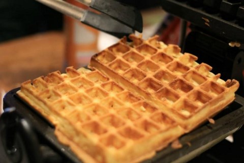Baking a waffle on a professional Belgian waffle iron