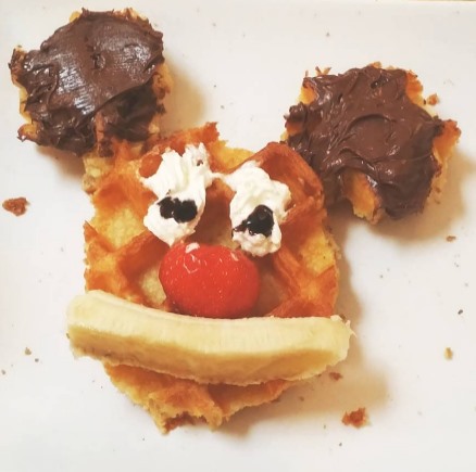 Mickey Mouse shaped waffle covered in Nutella