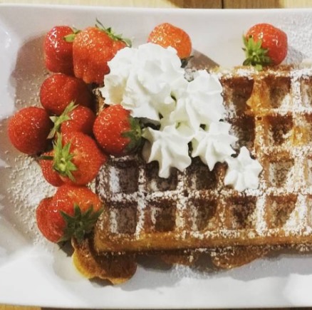 Belgian waffle with cream and strawberries